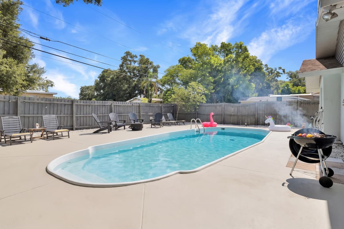 Not every pool day involves cannonballs. Some afternoons it's just quiet water, a book, and the sound of palms moving overhead while everyone else is out at the beach. The yard is private enough to make that easy.