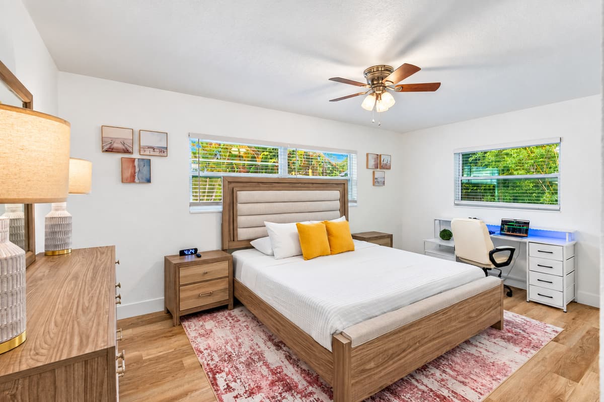 Relax in this airy and sunlit room, complete with a comfortable bed, soothing décor, and a serene view of the tropical greenery outside.