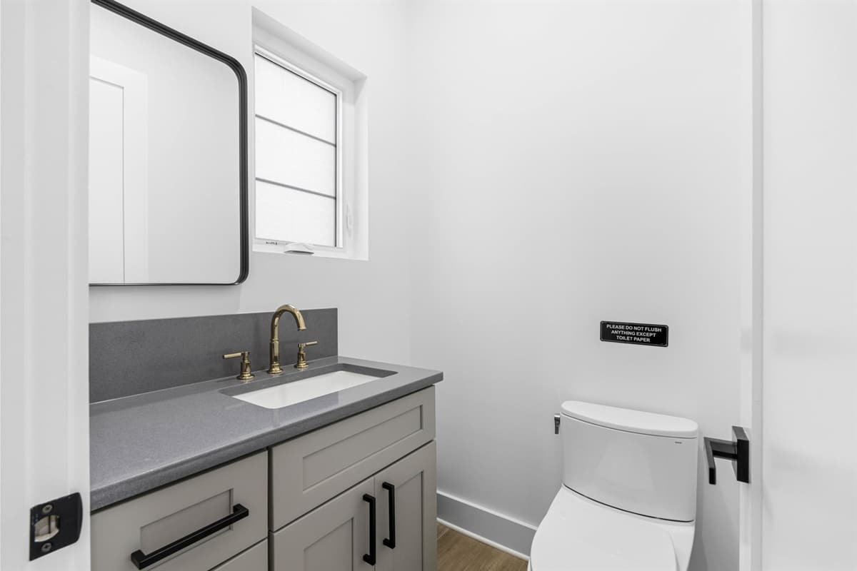 The layout of the half bathroom is both functional and inviting. With a well-thought-out arrangement, the space allows for easy movement and accessibility, ensuring that it serves its purpose effectively without feeling cramped.