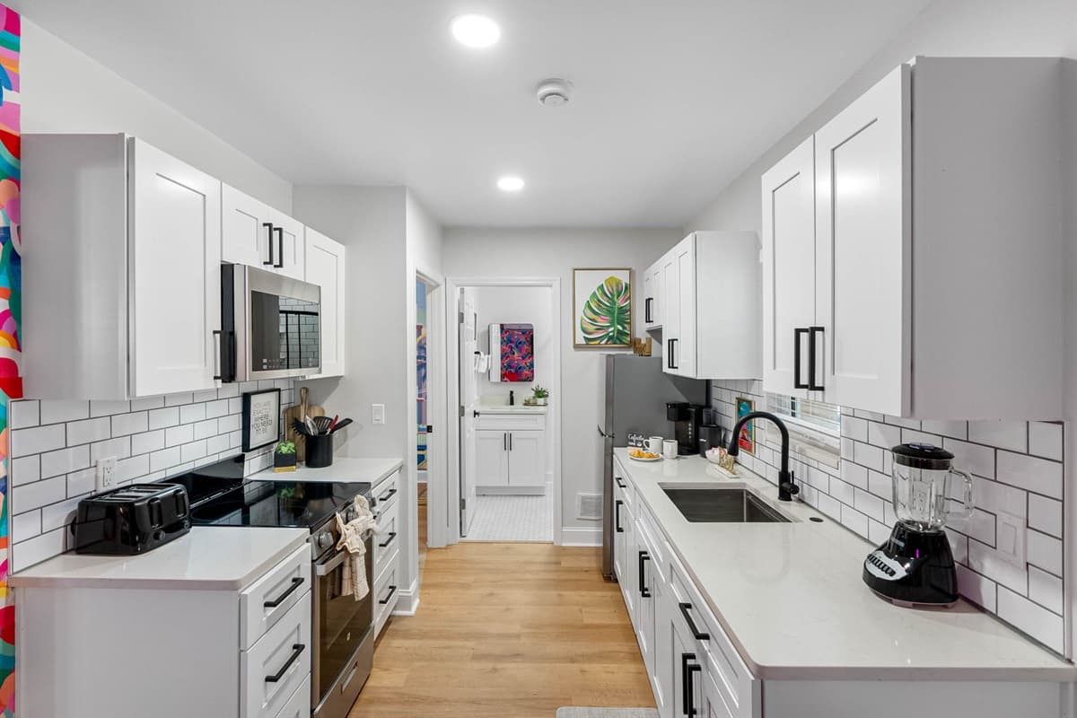 This modern, all-white kitchen provides the perfect backdrop for all your culinary adventures.