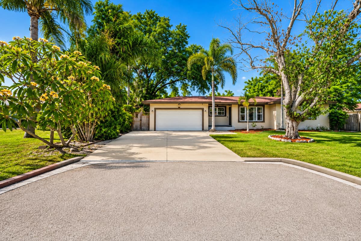 Wide front exterior shot showcasing the home’s quiet residential setting and spacious parking area.