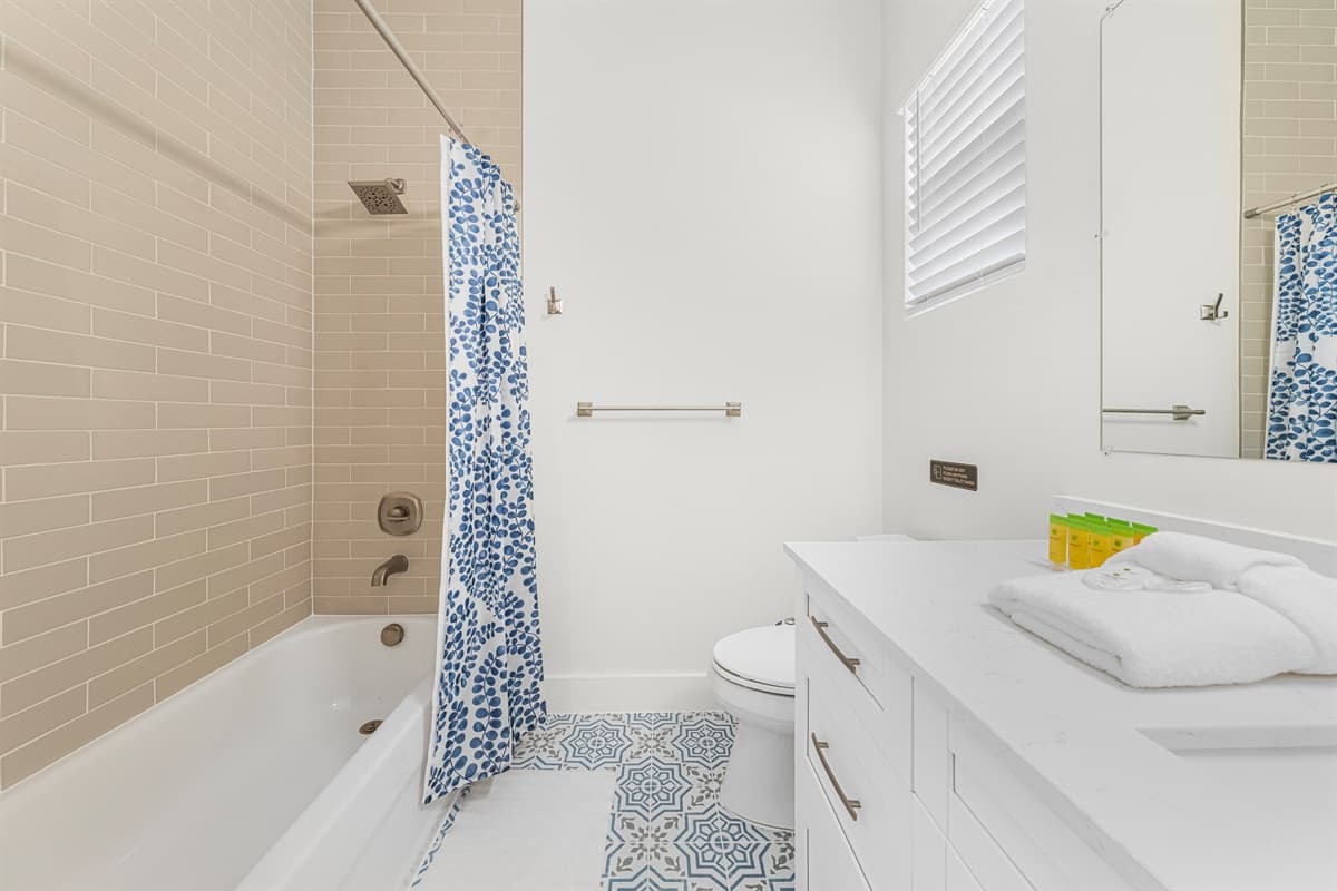 Full bathroom featuring tiled shower and bright, functional layout.
