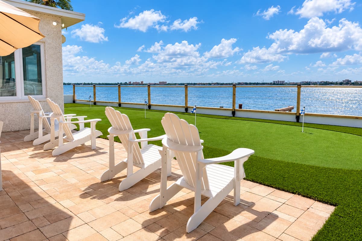 Patio lounge chairs facing the water.