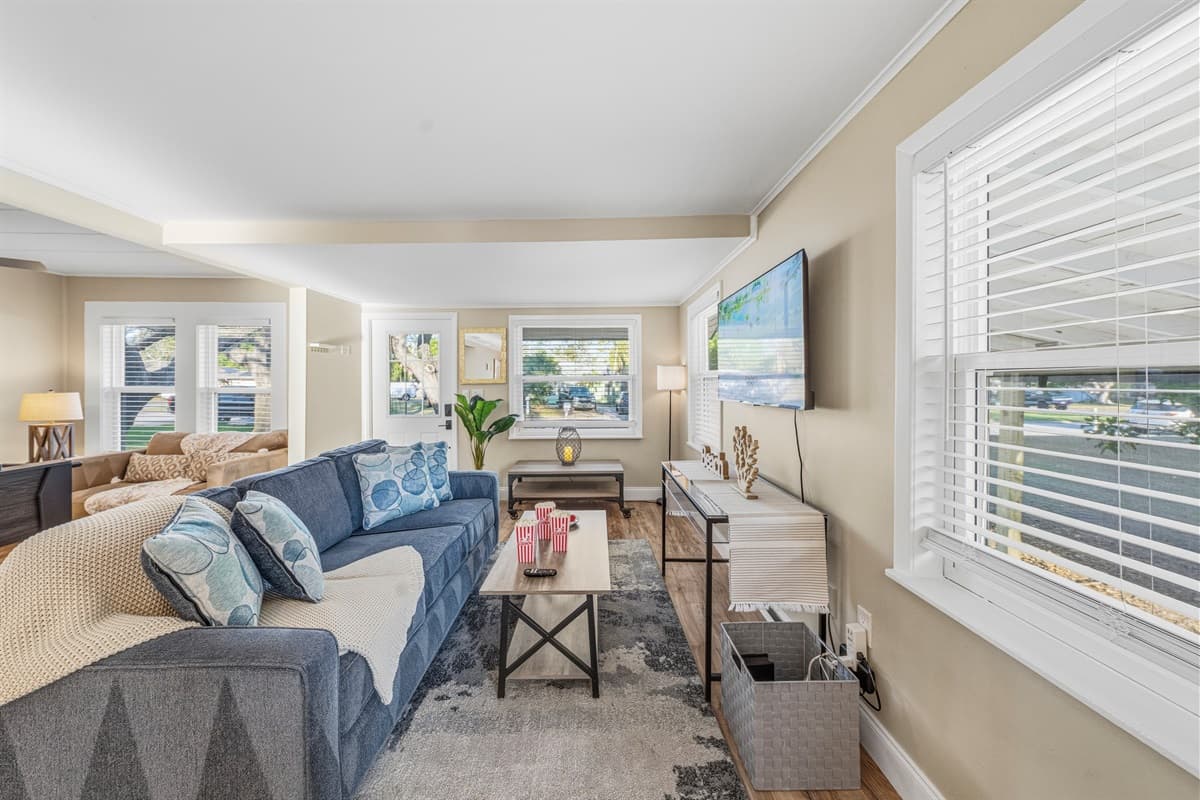 Cozy living room with plush seating and a large TV for relaxing evenings.