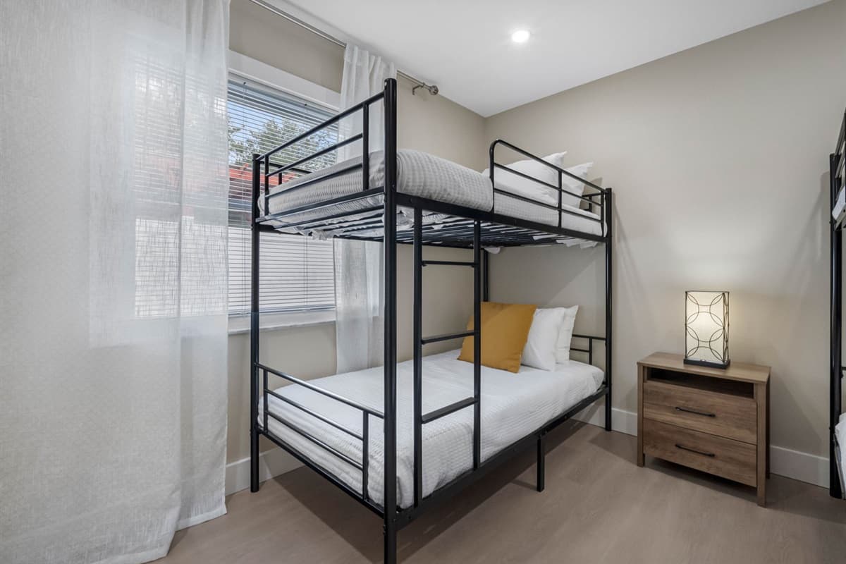 Designed for group stays, this room features two sets of twin bunk beds, ample lighting, and a peaceful vibe for restful nights.
