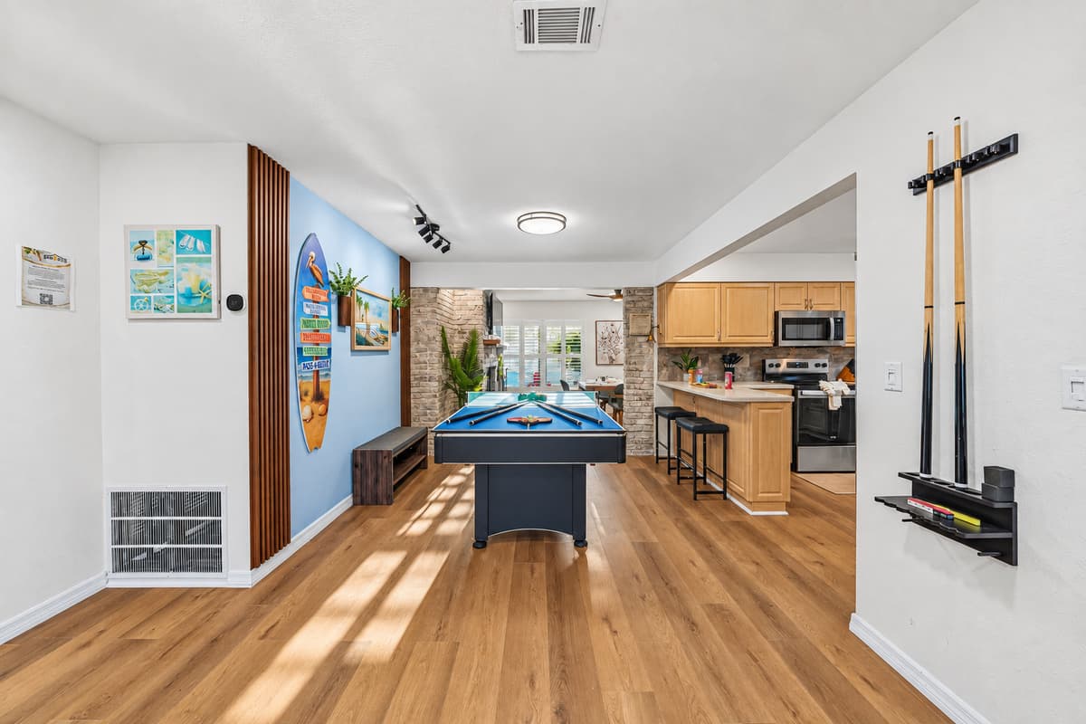 Spacious entertainment zone connecting the game area to the kitchen—great for social gatherings 