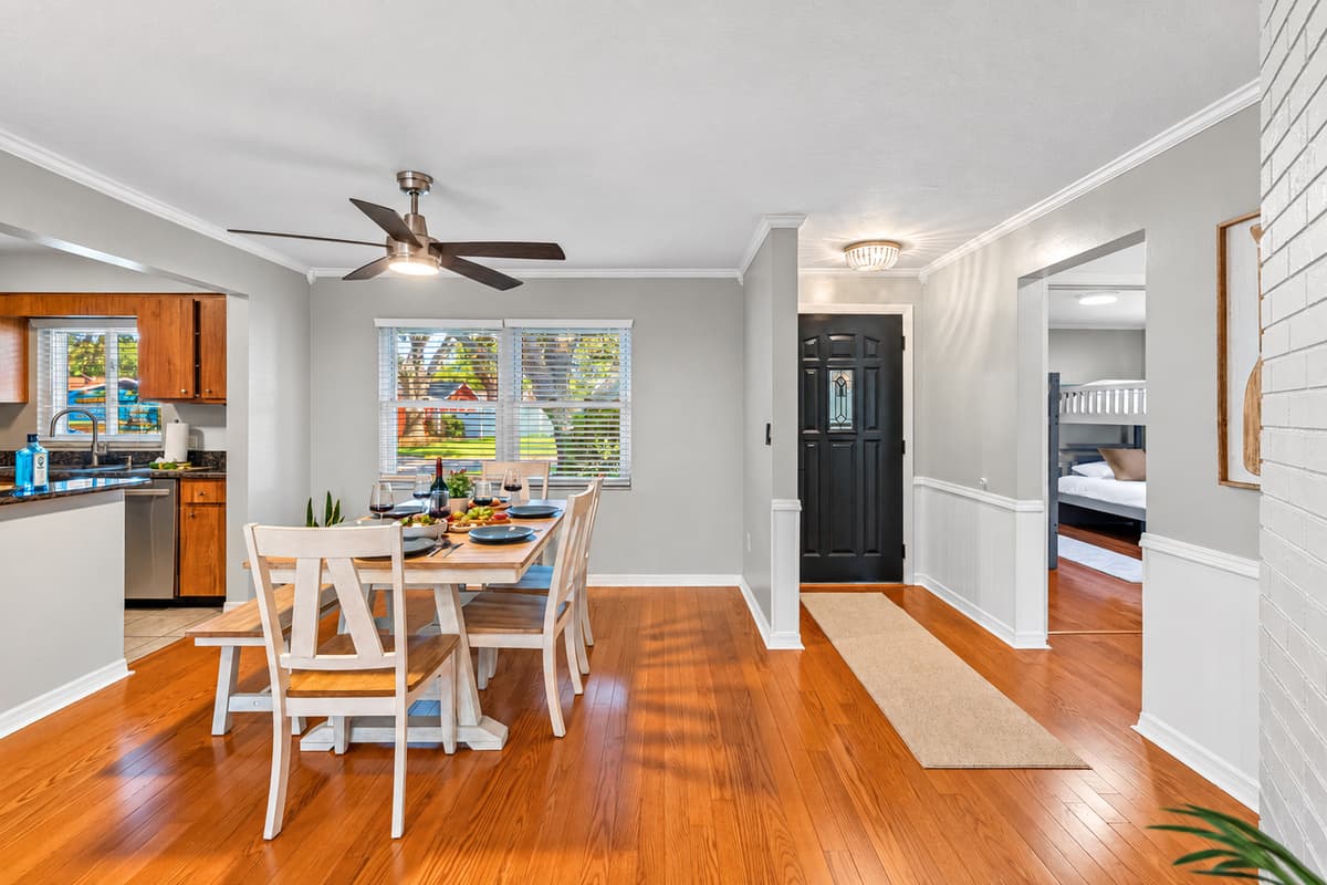 This warm, open-concept dining space is perfect for shared meals, laughter, and wine-filled evenings. Set with stylish tableware and a fresh charcuterie board, it’s ready for your next memorable moment.