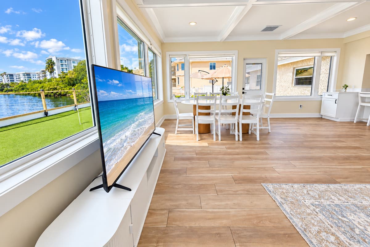 Waterfront living room with comfortable seating and wide water views.