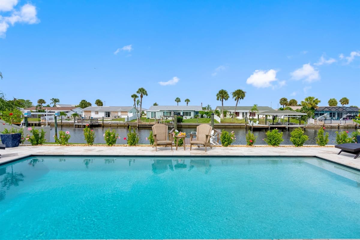 Relax by your private pool with stunning canal views and endless Florida sunshine.