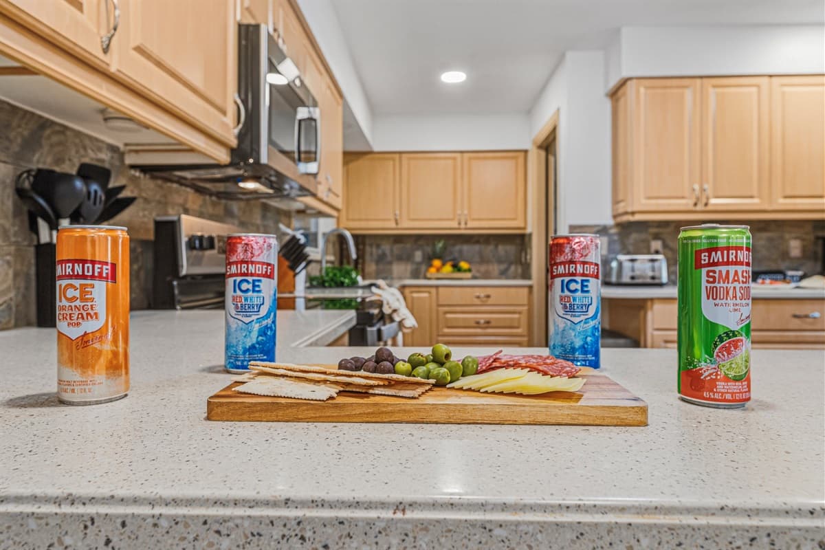 Kitchen counter styled with snacks and beverages—perfect for entertaining or casual bites 
Food and drinks shown are for staging purposes only and are not included.