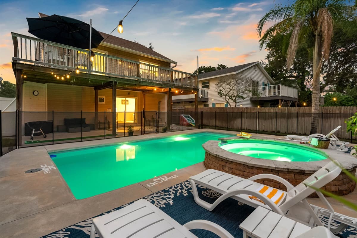 Surrounded by trees and privacy fencing, this poolside area offers tranquility and peace.