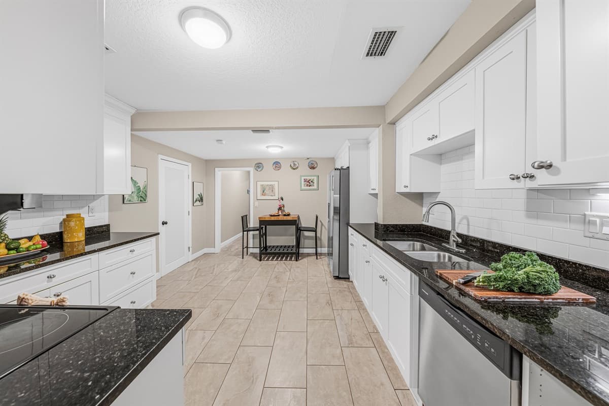 Spacious galley-style kitchen with extended countertops and easy access to dining area.