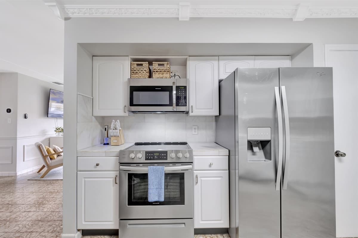 The gleaming silver appliances are a reflection of modern luxury, promising both functionality and aesthetics.
