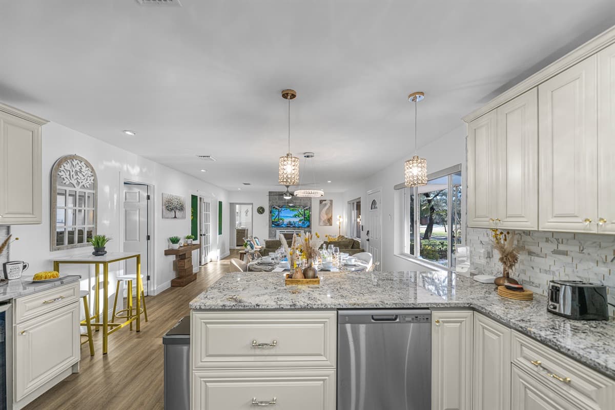 A bright, chef-inspired kitchen featuring elegant cabinetry, granite countertops, and modern appliances—perfect for cooking, gathering, and entertaining.