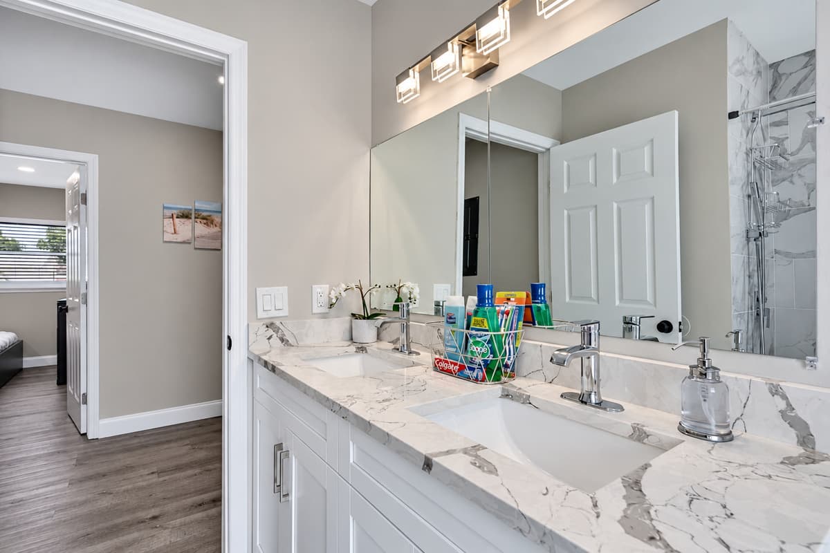 Stunning bathroom with sink, toilet, and walk-in shower.  Enjoy a relaxing bath after a long day of travel from your home to your home away from home. If you like this property, send us a message now!