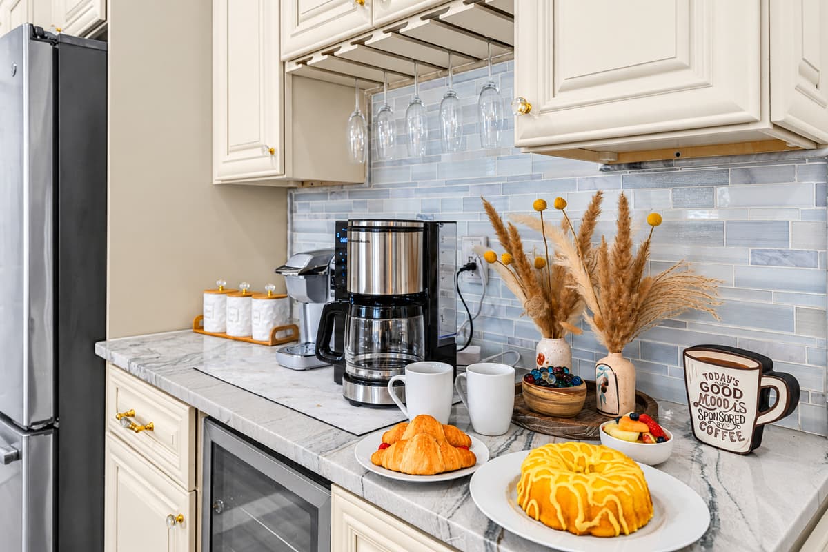A bright and inviting coffee station set within a beautifully designed kitchen. Welcoming touch—perfect for enjoying a relaxing morning at the property.