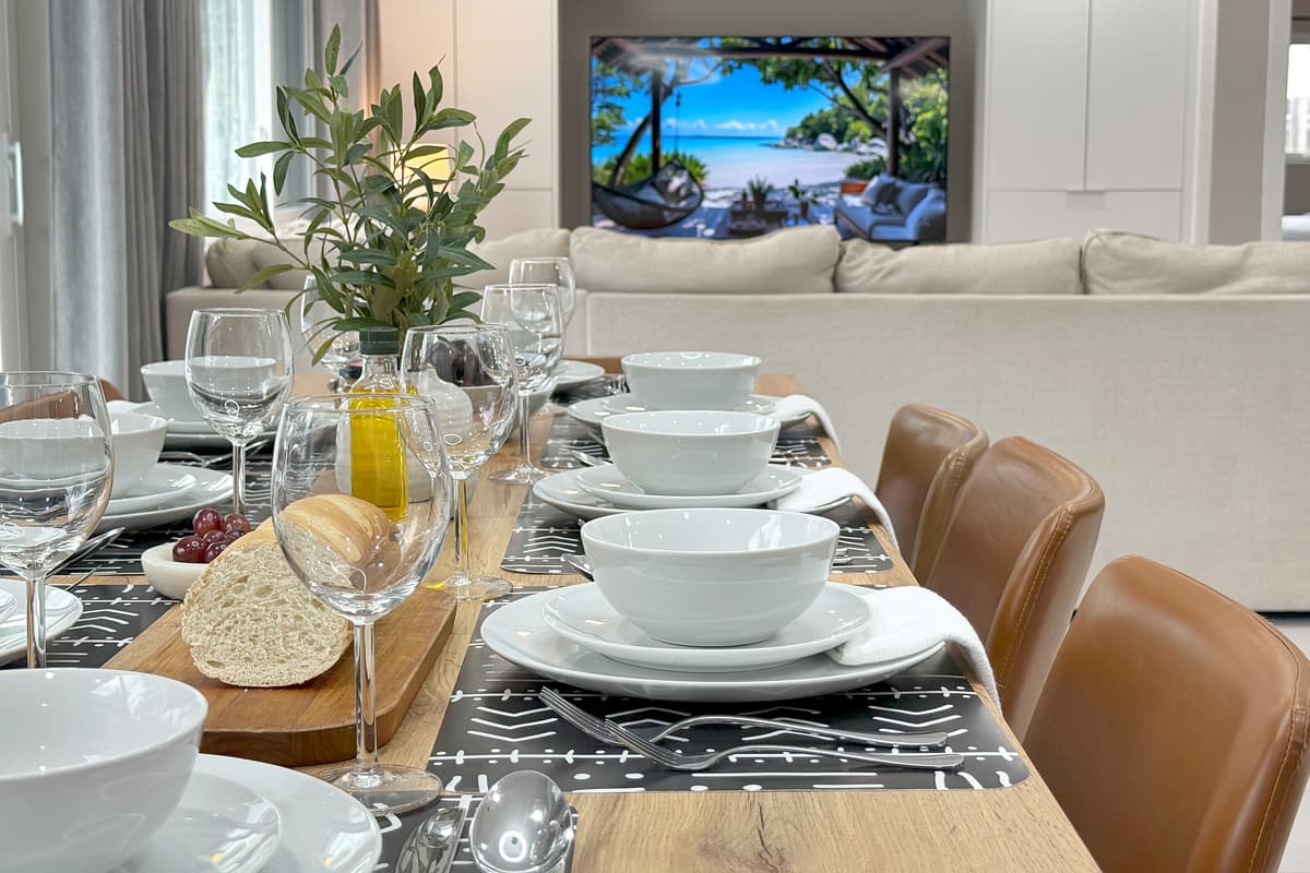 This is the seat everyone wants: dinner in front of you, the flatscreen just past it. Nobody's craning their neck for this one.