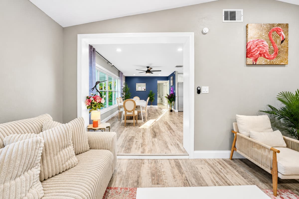 View from the living room toward the dining area, showcasing the home's spacious layout and natural lighting.