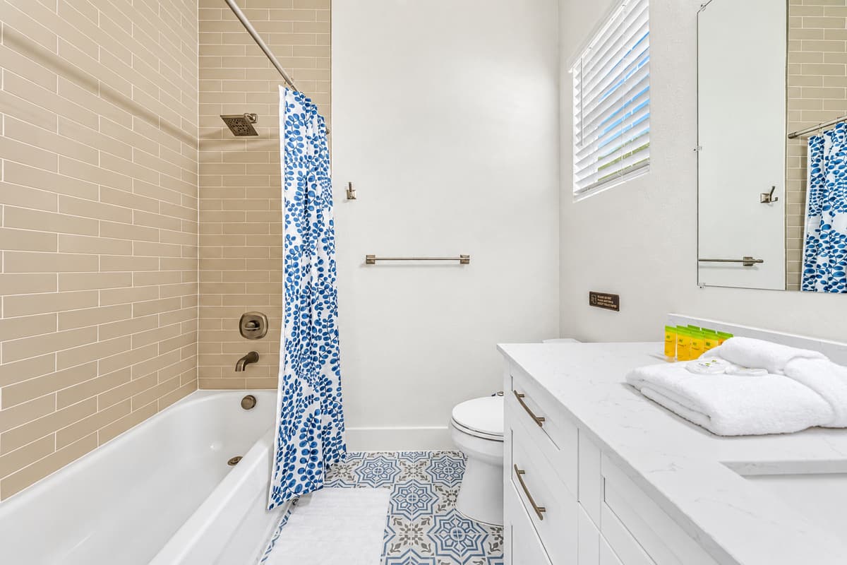 A bathroom you can actually unwind in — deep tub, good light, towels provided.