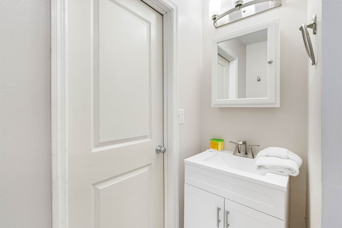 The standout feature is the generously sized walk-in shower, finished in rich natural stone tiles with a textured pebble-style floor.