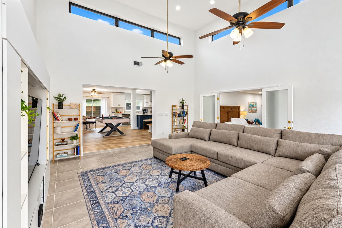 Stay cool and cozy with dual ceiling fans and soft, neutral-toned furniture.
