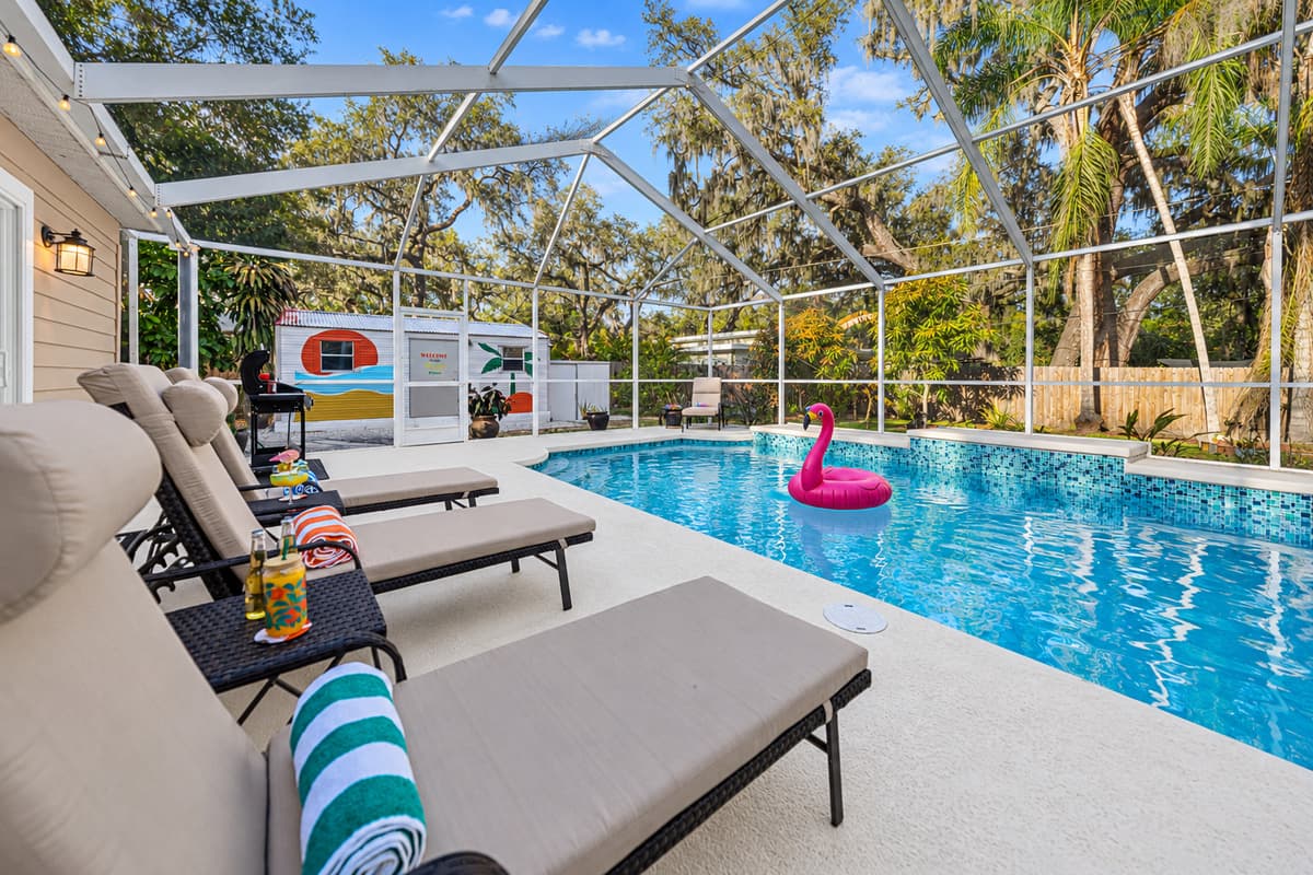 Stretch out and unwind in the spacious screened-in pool area, complete with cozy loungers.