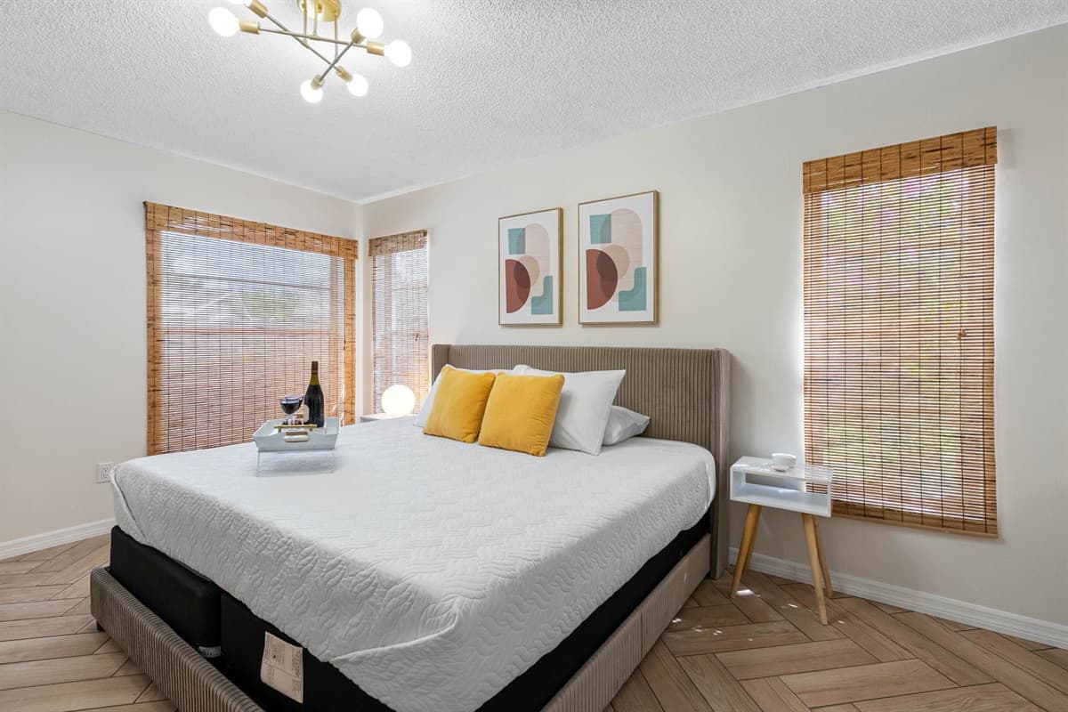 A soothing oasis featuring warm wood elements, contemporary art, and a king-size bed wrapped in crisp linens.