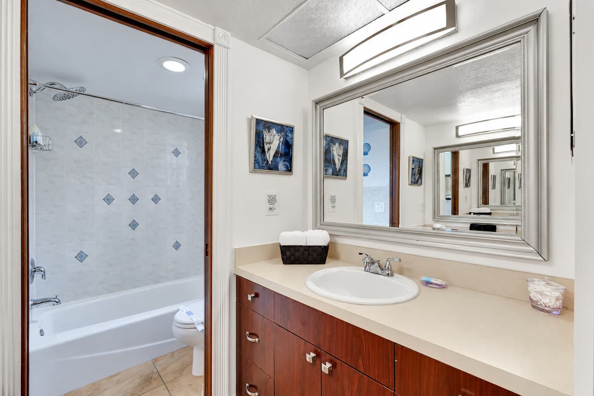 The bathroom features modern fixtures and elegant finishes, creating a spa-like atmosphere.