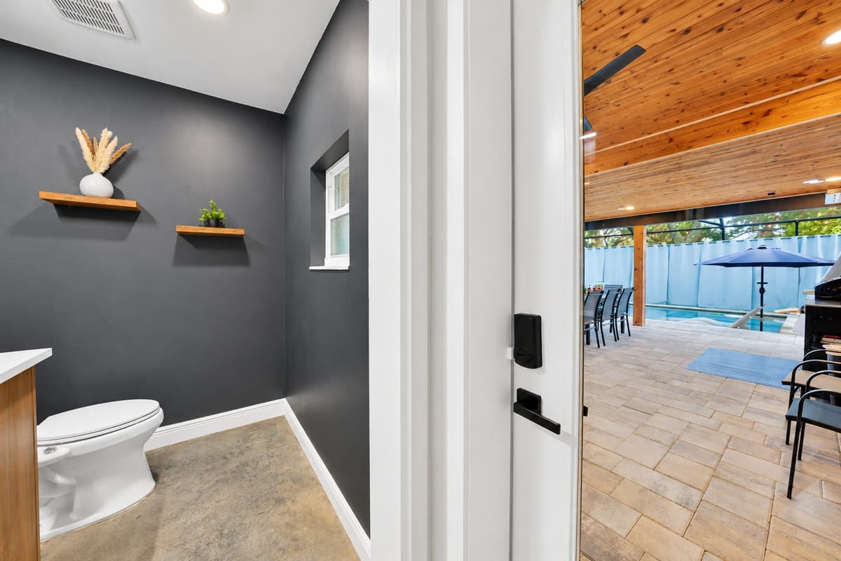 Half bath by the pool door, exactly where you need it. Nobody tracks water through the bedrooms, and nobody queues upstairs on the way back in from the lanai.