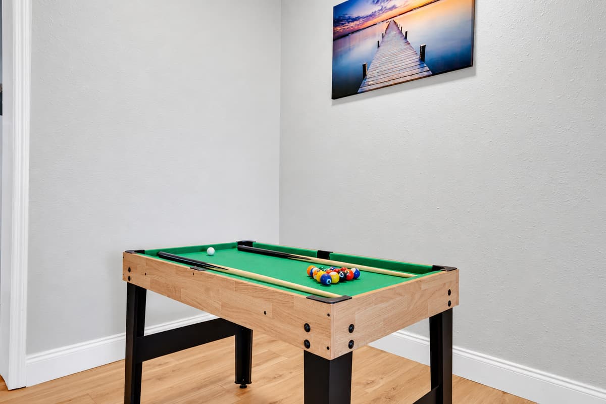 The pool table is where the after-dinner rivalry starts. Someone racks, someone swears they never play, and an hour later nobody has gone back outside. It earns its place on night one and holds it for the rest of the week.