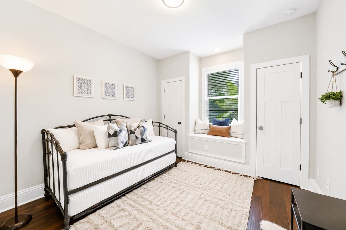 This bonus space features a cozy twin daybed and window nook, perfect for relaxing or accommodating an additional guest.