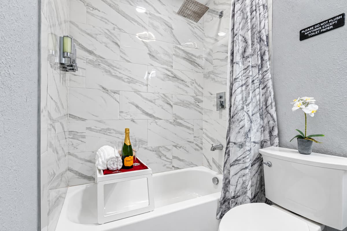 Stunning bathroom with bathtub, sink, toilet and walk in shower.  Enjoy a relaxing bath after a long day of travel from your home to your home away from home. If you like this property, send us a message now!