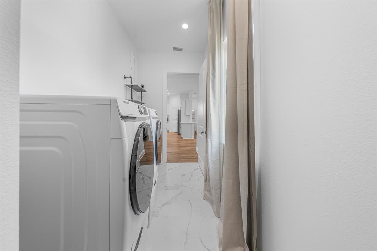 Laundry area with modern appliances and easy access from the main living space.