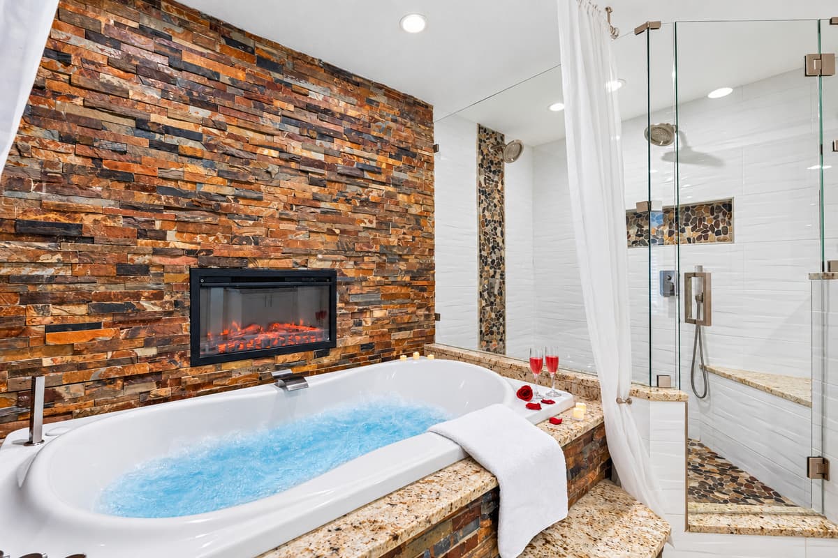 Features a deep soaking tub perfectly positioned in front of a built-in TV.