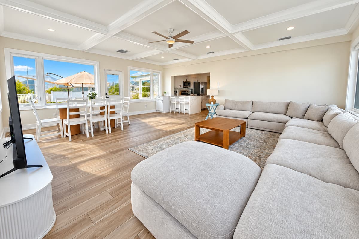 Waterfront living room with comfortable seating and wide water views.