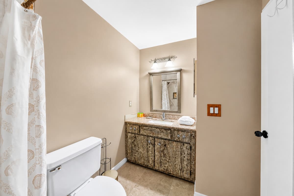 Clean and spacious bathroom featuring a large vanity, fresh towels, and essential amenities.