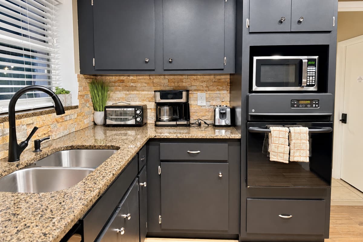With ample granite countertop space, dual sinks, and a clean, organized layout, this kitchen is ideal whether you're preparing family dinners or late-night bites.