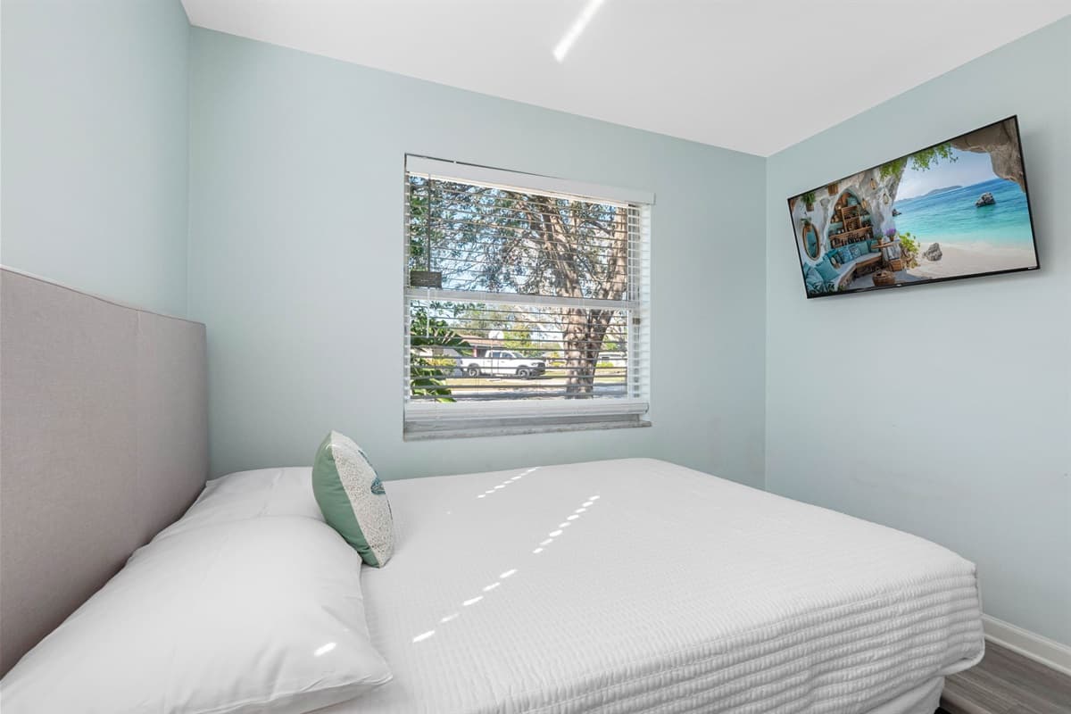 This generously sized room features two plush double beds, providing ample sleeping space for multiple guests.