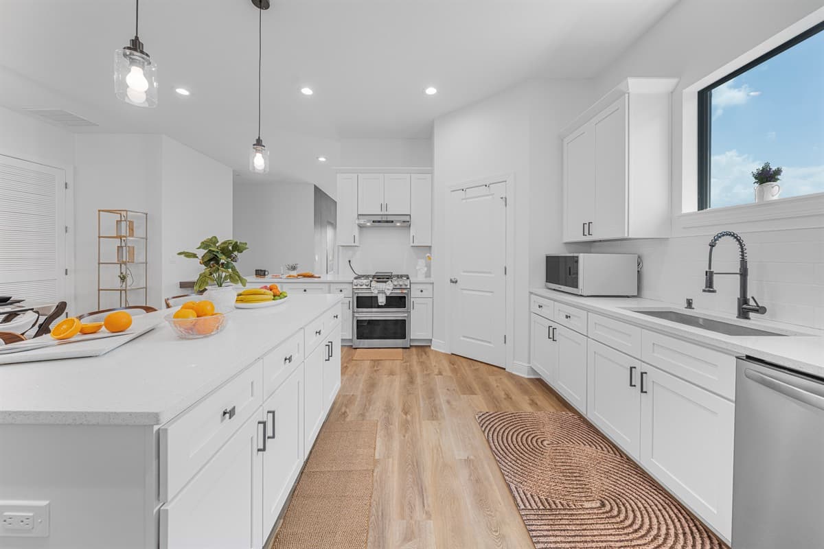 Long kitchen view with ample counter space, modern appliances, and functional design.