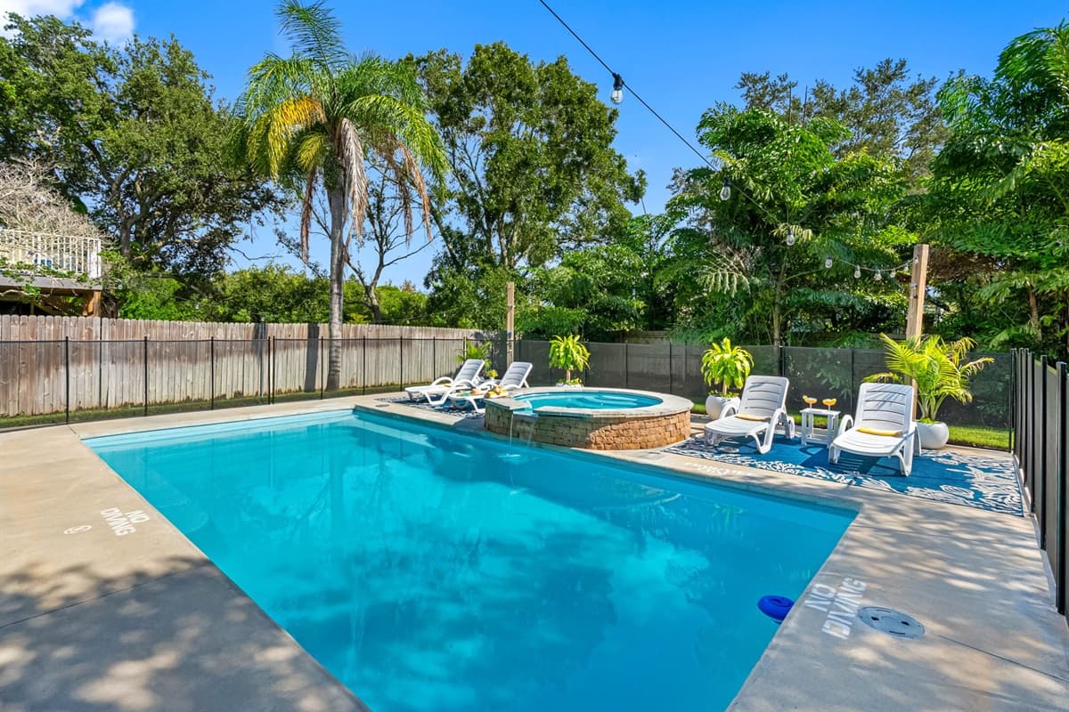 Escape to this beautiful Crystal Beach home featuring a sparkling pool, sun loungers, and plenty of outdoor space for family fun.