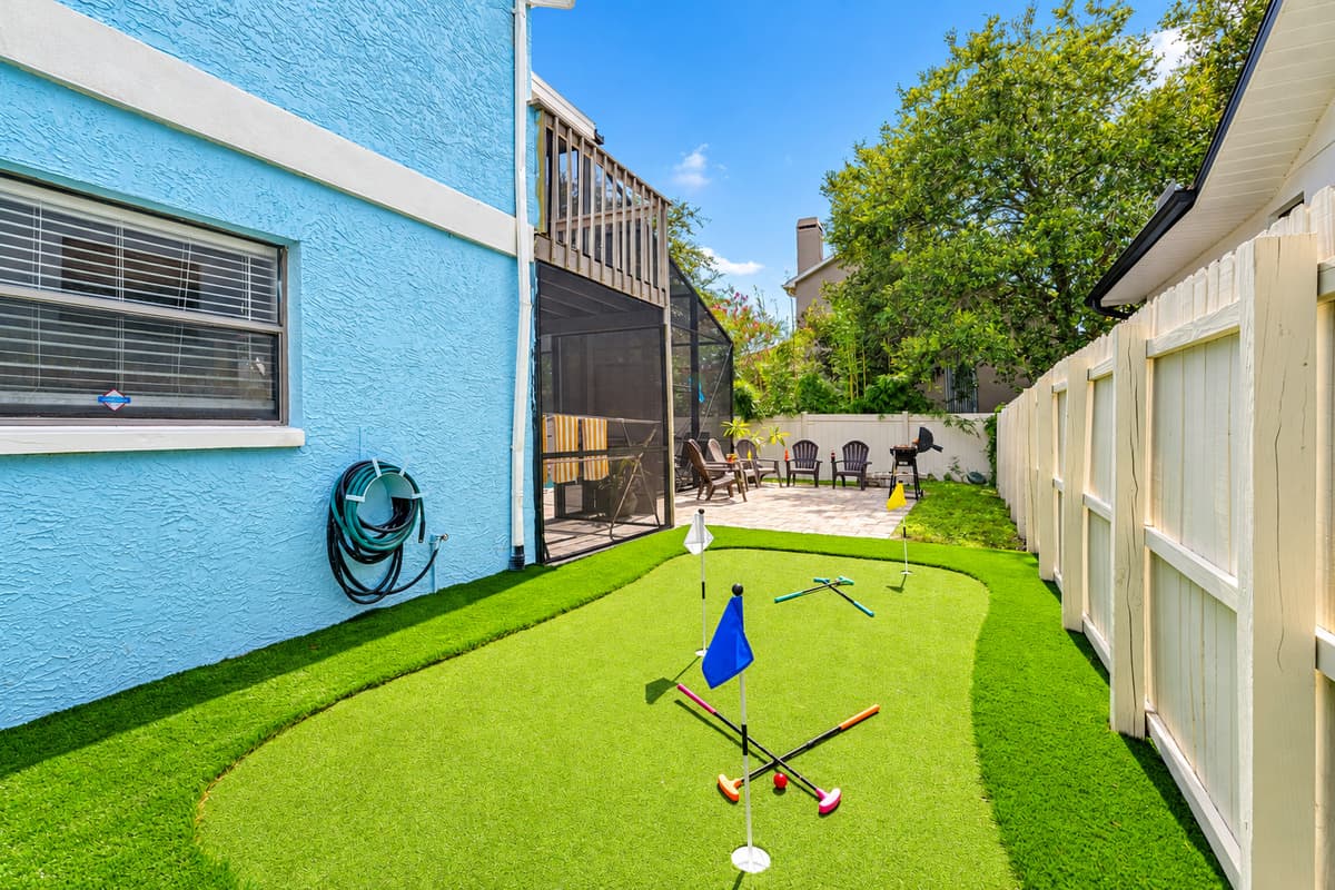 This unique side yard is home to a playful putting green and bright cornhole boards—great for casual fun or a little friendly competition.