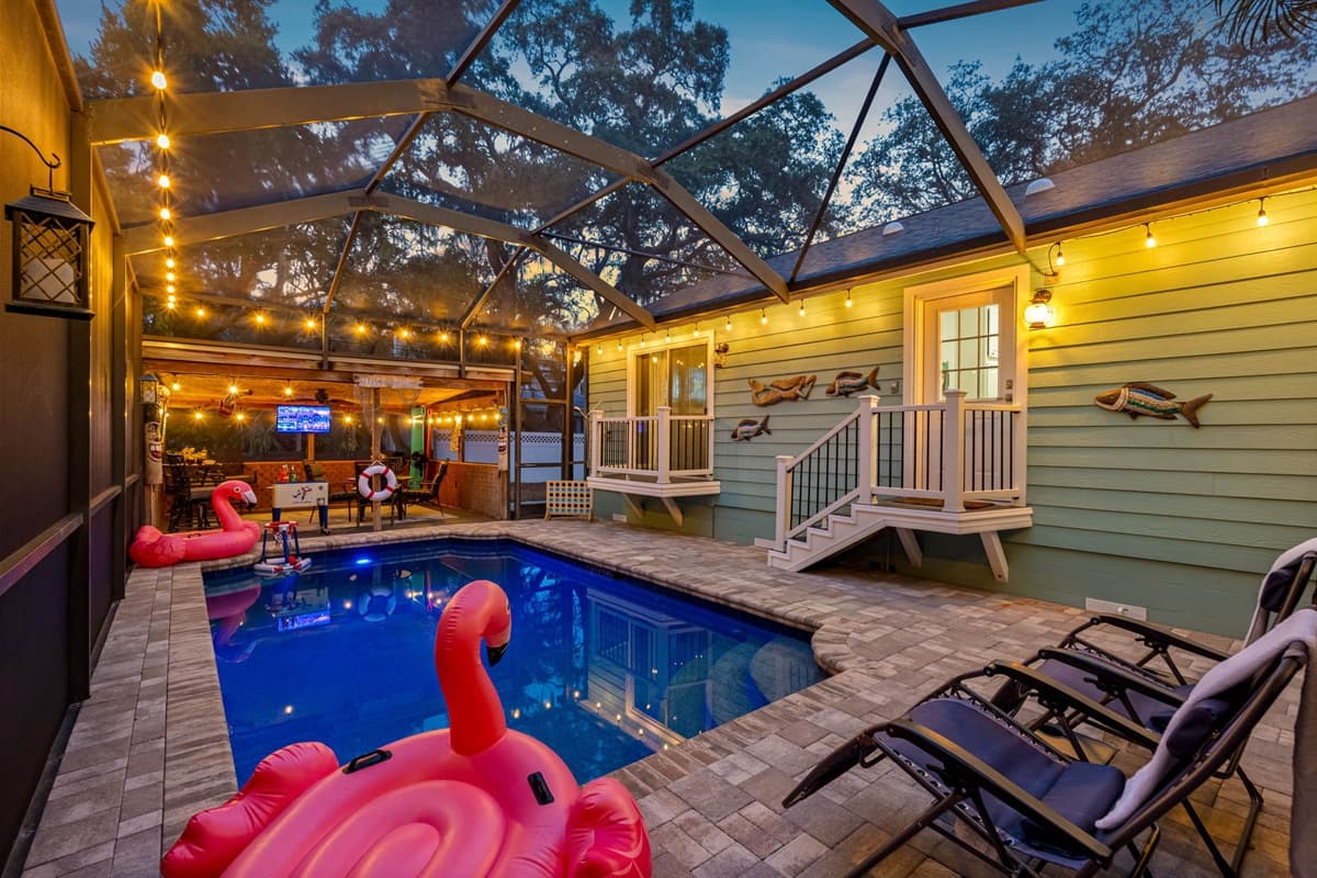 This pool area features a covered tiki-themed lounge, outdoor TV, and fun décor, making it the ultimate hangout spot.