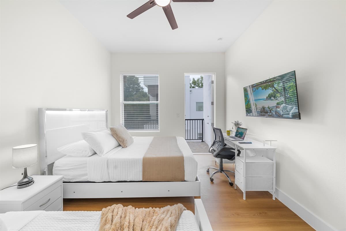 Vaulted ceilings and a modern ceiling fan create an airy, comfortable atmosphere. This bedroom is your private sanctuary.