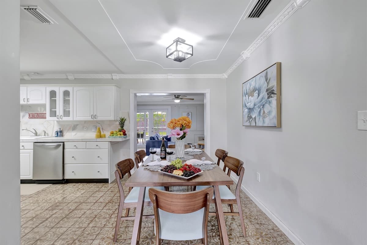 Nestled conveniently near the kitchen, you'll discover a stunning 6-seater wooden dining table that exudes rustic elegance.