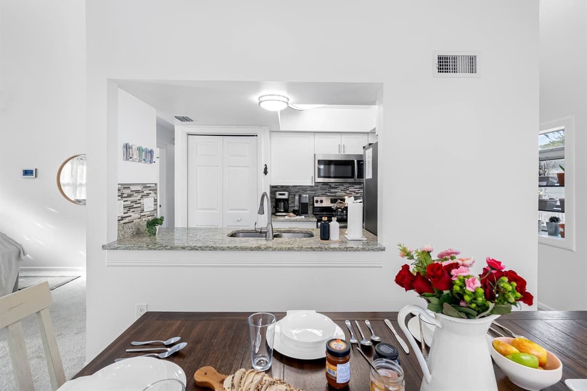 Enjoy meals together with a seamless flow between the dining table and the kitchen pass-through bar. Perfect for family gatherings.