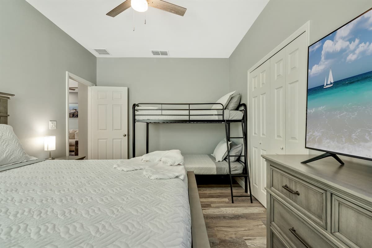The bunk bed adds a touch of whimsy and excitement, perfect for children or adventurous guests seeking a cozy retreat.