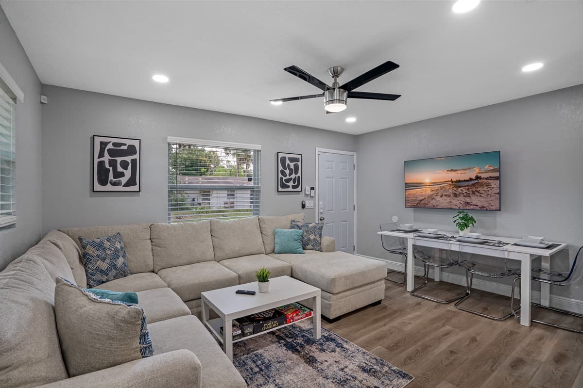 Experience modern comfort in the spacious living room, featuring a large smart flat-screen TV, perfect for streaming your favorite show