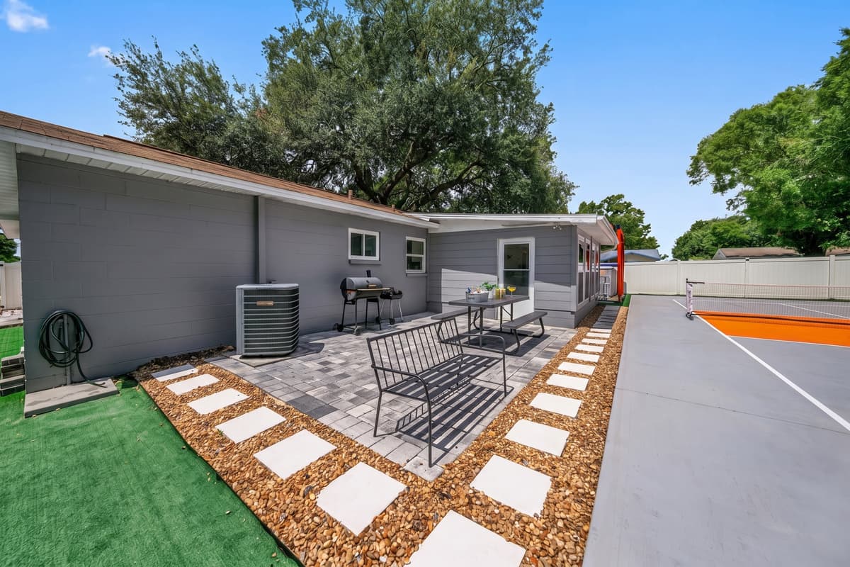 Enjoy outdoor dining and lounge seating just steps from your private pickleball court—perfect for relaxing between games.