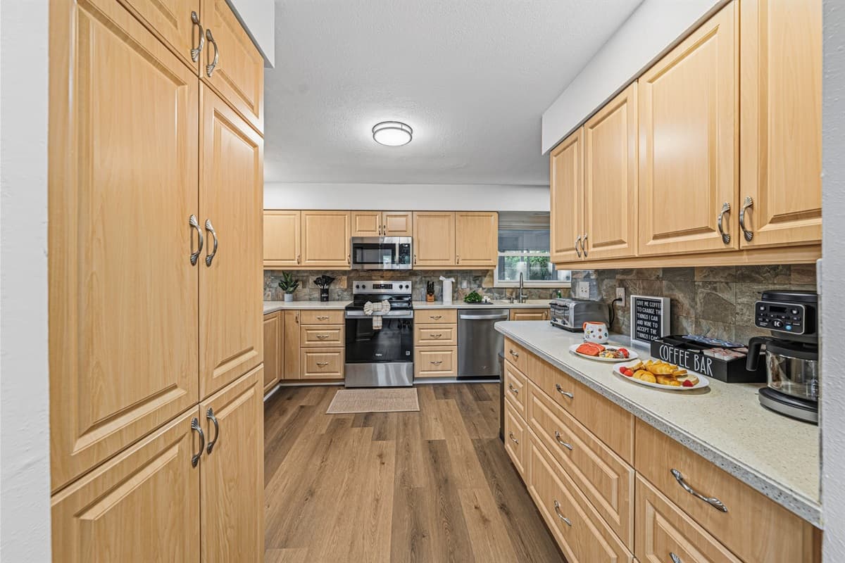 Spacious kitchen with ample cabinetry and prep space, ideal for cooking for large groups 