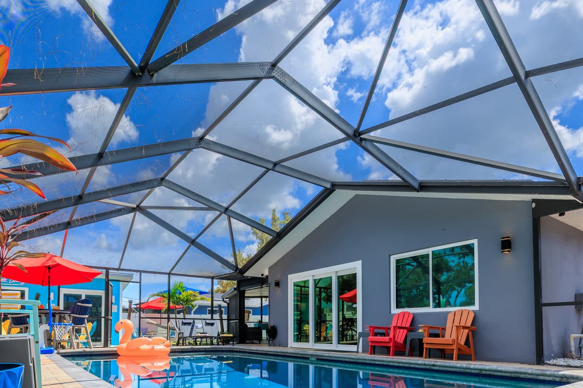 Screened-in pool and outdoor lounge space.